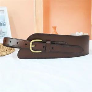 Detailed view of the wide brown leather waist belt with vintage metal buckle for dresses.