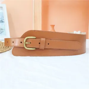 Wide brown leather waist belt detail with vintage metal buckle, versatile for dresses.