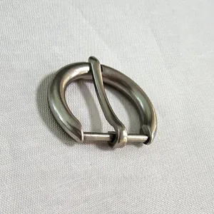 Detailed close-up shot of a matte silver alloy pin buckle accessory for apparel.