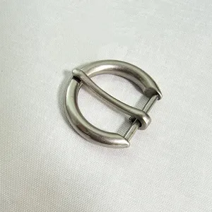 Close-up of silver zinc alloy round pin buckle, D-ring belt buckle detail for women fashion.
