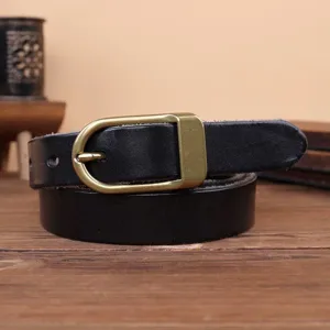Detailed view of black leather belt featuring a classic vintage brass metal pin buckle.