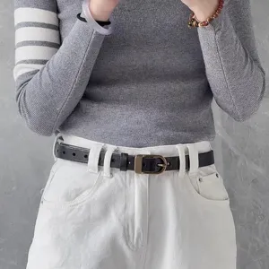 Metal pin buckle and slim black belt accessory for casual wear and daily outfits style.