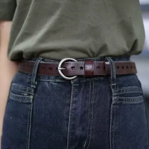 Women's vintage brown leather belt with star cutouts and stylish round metal buckle.