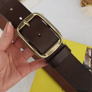 Detailed view of vintage genuine leather belt with metallic pin buckle, casual dark brown design.