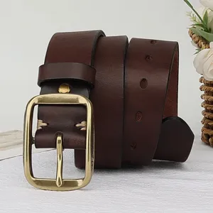 Detailed shot of retro brown genuine leather belt with brass square buckle and stitching.