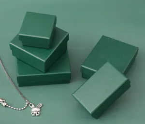 Detailed view of peacock green jewelry boxes in various sizes for rings and necklaces.