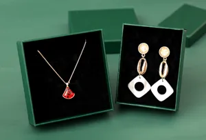 Close-up of elegant dark green jewelry boxes with velvet lining for necklace and earrings