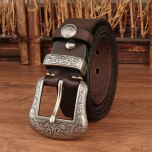 Detailed close-up view of the retro engraved metal buckle and genuine leather belt texture.