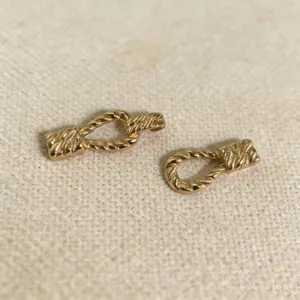Closeup view of gold alloy rope twist toggle buckle accessories for women clothing.