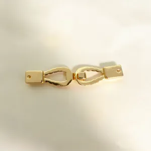 Detail view of golden metal alloy buckle, twist design for women clothing and belts accessories.