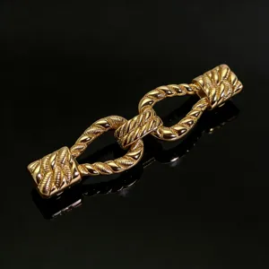 Detailed view of a golden metal twist buckle, stylish apparel accessory with rope design.