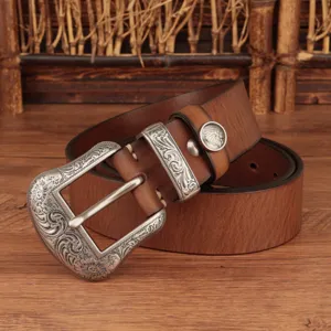 Vintage genuine leather belt detail showing carved silver metal buckle and stylish loop.