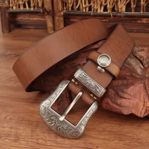 Men vintage brown genuine leather belt with ornate engraved silver metal buckle detail view.