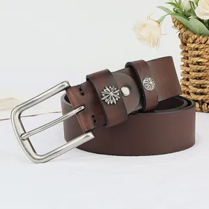 Detail shot of vintage brown leather belt with silver floral rivets and classic pin buckle.