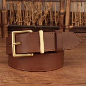 Close-up of brown genuine leather belt with a classic gold square buckle.
