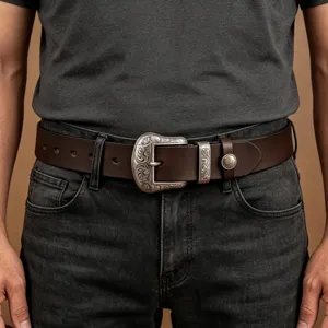 Men's vintage leather belt with ornate silver metal buckle, stylish retro jeans accessory.