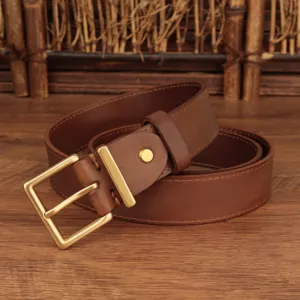 Close-up of classic square buckle and texture on women's brown leather belt