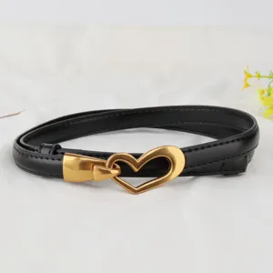 Genuine leather women's belt detail, stylish gold heart buckle design for dresses and shirts.