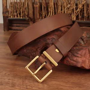 Detailed view of a brown genuine leather belt featuring a vintage gold square buckle.