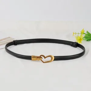 Black leather belt detail featuring vintage gold heart buckle for women fashion daily wear.