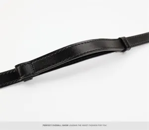 Black leather belt detail shot showing exquisite stitching and loop craftsmanship, elegant accessory.