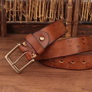 Detailed view of men retro brown leather belt with embossed palm trees and bronze metal buckle.