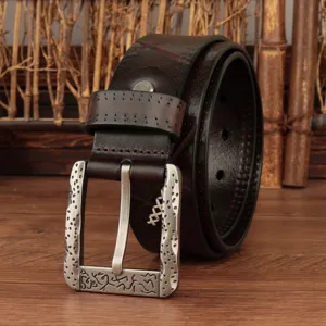 Close-up detail of retro genuine leather men's belt with distinctive textured metal buckle.