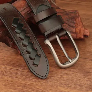 Close up view of the genuine leather braided belt detail showcasing the sturdy metal buckle.