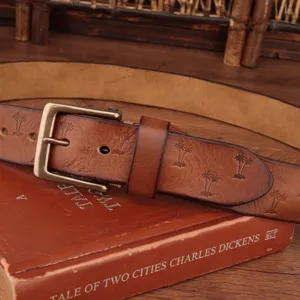 Vintage men's leather belt with embossed palm pattern and solid brass buckle detail.