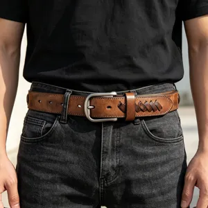 Detail shot of men's retro brown leather belt with stylish woven buckle strap and metal hardware.