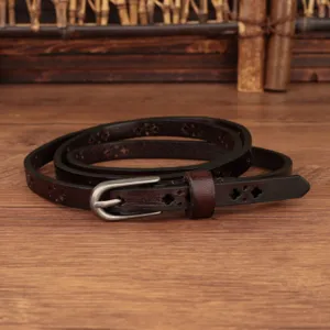 Close-up detail of genuine leather thin belt with hollow carving and retro metal pin buckle.