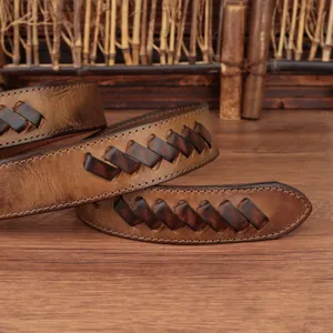 Close up view of the distressed brown leather woven belt showing fine craftsmanship and texture.