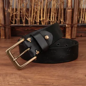 Close-up detail of vintage black genuine leather belt with bronze metal buckle and embossing.