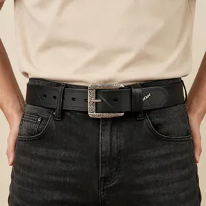 Detailed view of the men's vintage genuine leather belt with ornate silver buckle.