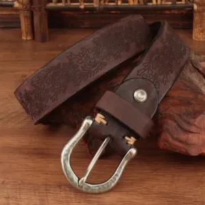 Detailed view of dark brown genuine leather carved belt with vintage floral buckle.