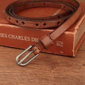 Close-up of brown genuine leather thin belt featuring retro hollow-out patterns and metal buckle.