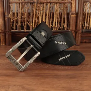 Detailed shot of men vintage black leather belt featuring ornate metal buckle and cross stitching.