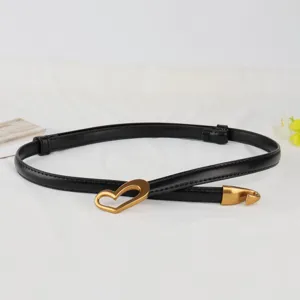 Women's black leather belt with gold heart buckle, stylish versatile thin strap for dresses.