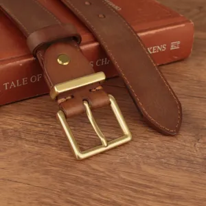 Close-up detail of a classic square brass buckle on a premium brown leather belt