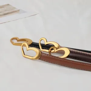 Women's genuine leather belt with vintage metal heart buckle, stylish accessory for dresses and coats.