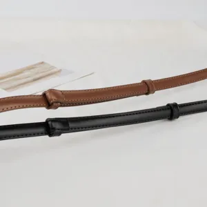 Detailed close-up of genuine cowhide women leather belt straps in brown and black colors.