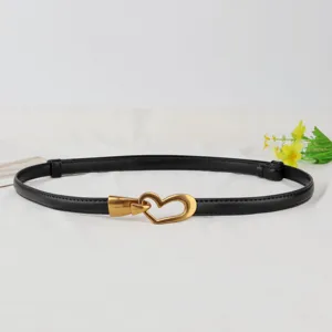 Women genuine leather thin belt with vintage gold heart buckle, stylish waist accessory.