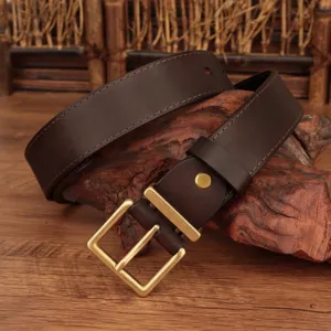 Close-up detail showing texture of brown top grain leather belt with gold square buckle