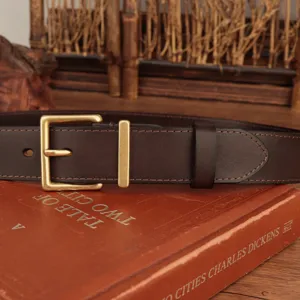Close-up of classic brass square buckle on dark brown top grain leather belt.
