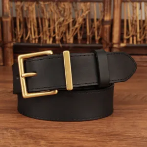 Detail view of a women's black genuine leather belt featuring a classic matte gold buckle