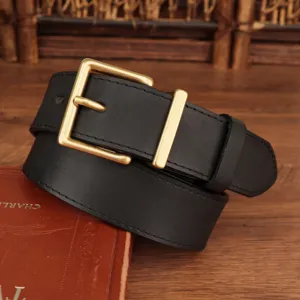 Detailed close-up view of women's black genuine leather belt with a classic gold square buckle