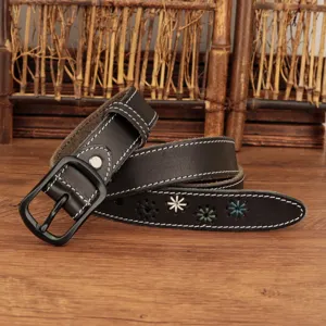 Close-up of black leather women's belt featuring white stitching and floral embroidery