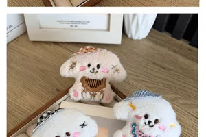 Close-up of cute plush puppy brooches with colorful plaid hats and embroidered details