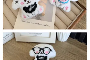 Close-up of cute plush puppy brooch with black round glasses and soft fur.