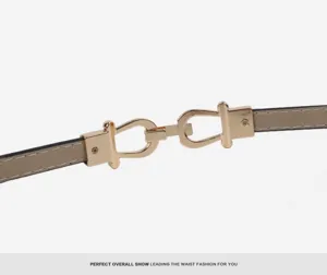 Slim patent leather belt detail showcasing elegant metal horseshoe buckle for women's waist.